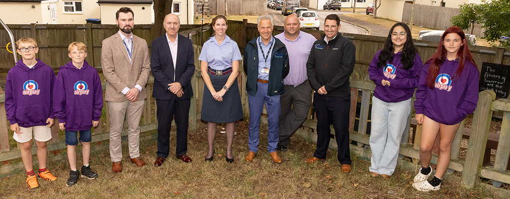 Contributors to the Conservation Garden stand in an arc for a group photo.